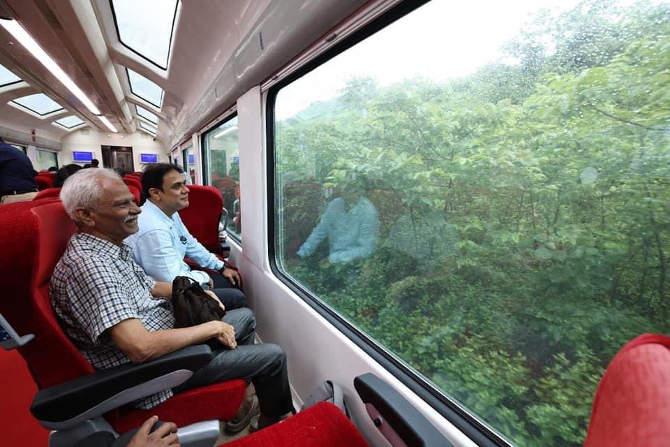An old age person enjoying scenic view from a Vande Bharat train
